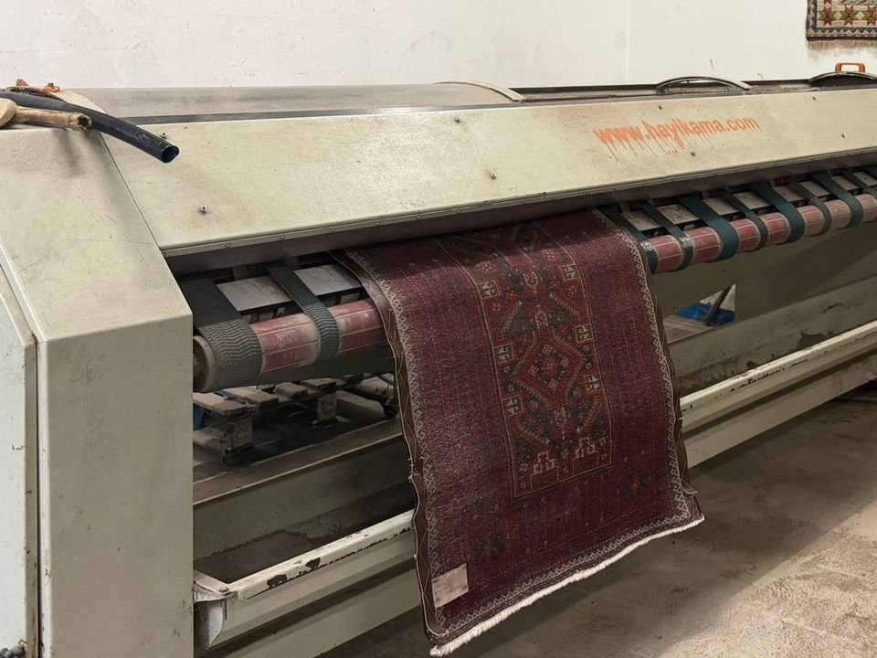 Tapis passant dans la machine de lavage à brosses de l'atelier